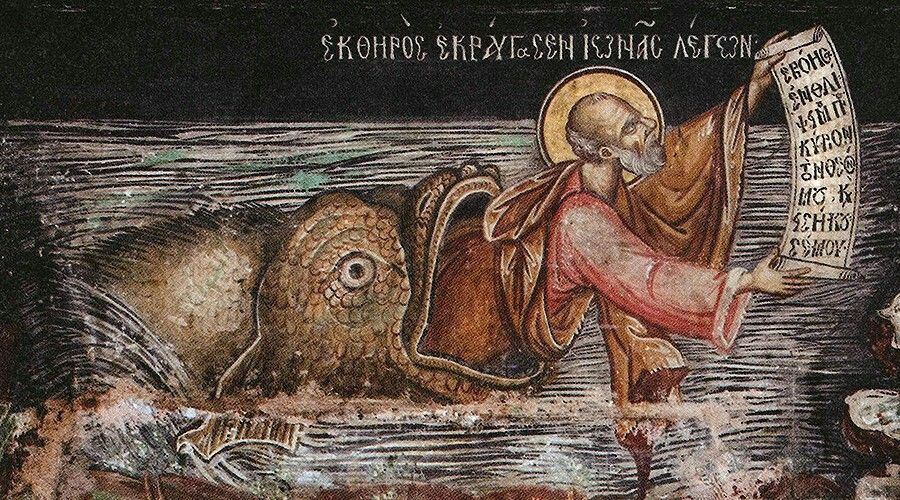 Jona på väg ut ur valen med en skriftrulle med budskapet han ska framföra